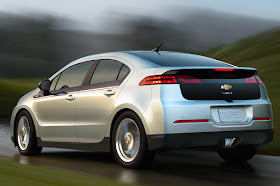 Rear 3/4 view of silver 2012 Chevrolet Volt driving in the rain