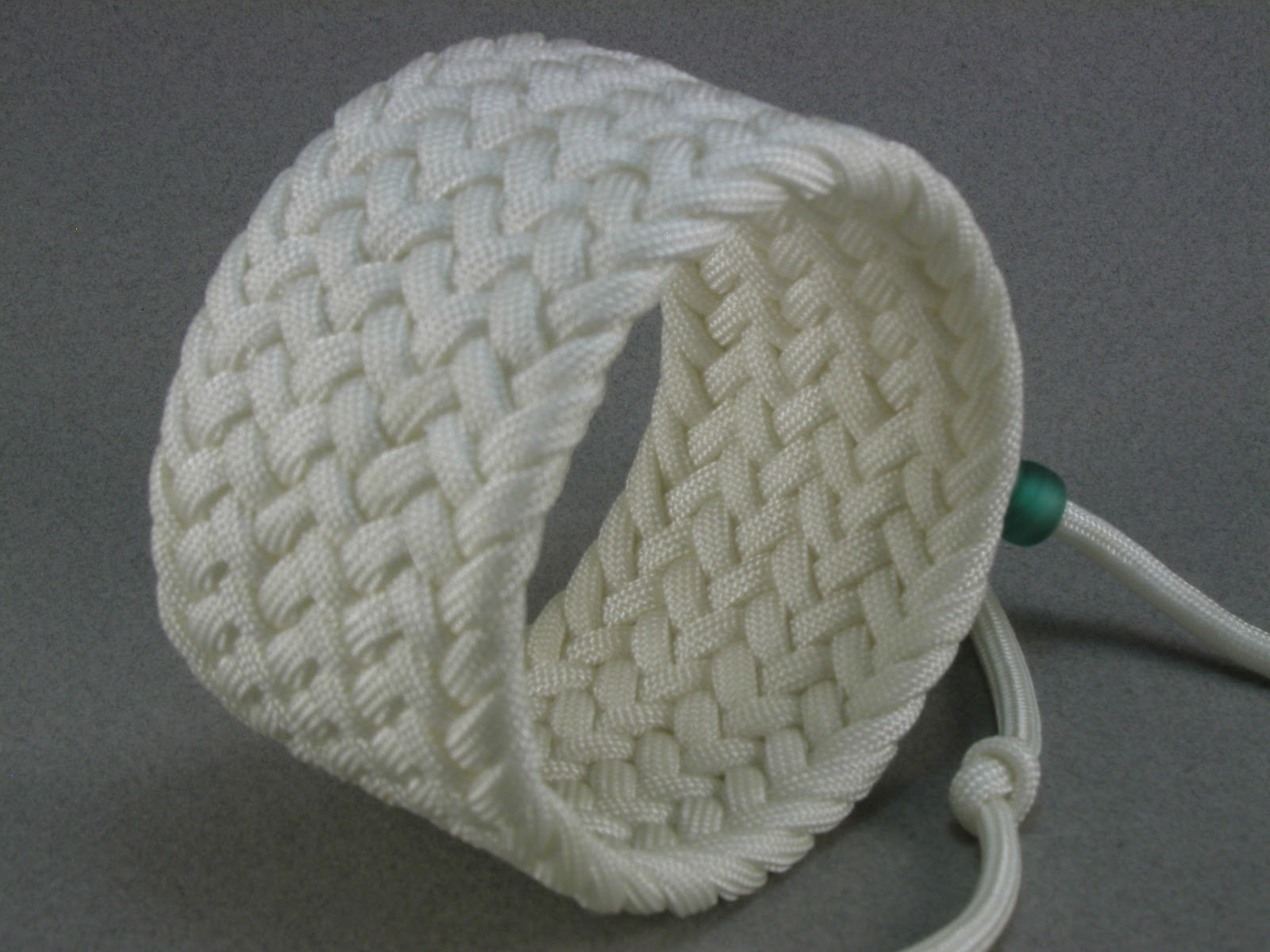 Knots and fiber bracelets: white paracord herringbone weave turks