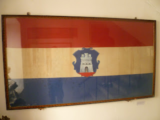 Large old Croatian flag perched upon wall 