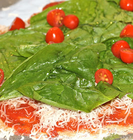 Spinach and baby tomatoes atop a wholewheat pizza on www.anyonita-nibbles.com