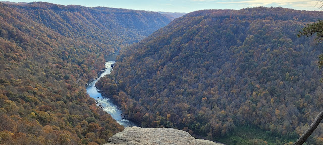 A river in the distance at the bottom of a deep gorge.