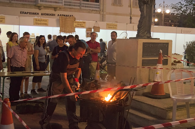 A blacksmith creating and manipulating objects using fire in Limassol, Cyprus during Kataklysmos - festival of flood.