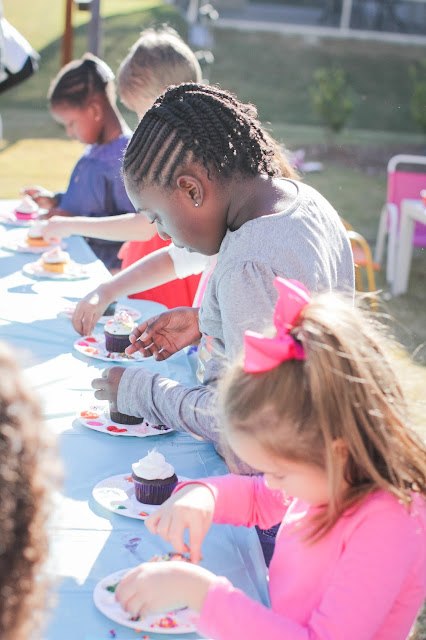 Girls decorating cupcakes at a Rainbow Party or an art party