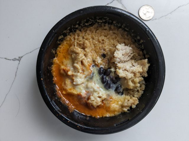 Real Good Foods' Chicken Burrito Bowl next to a quarter.