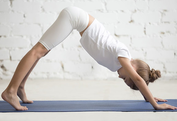 Girl doing downward-facing dog pose