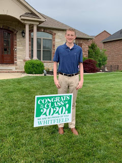 My friend Marla's son, Eric, standing in front of a Class of 2020 sign in the grassy front yard of his house.