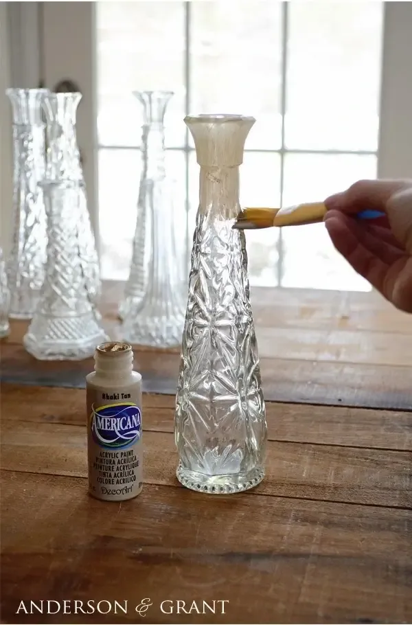 Painting glass bud vase with tan craft paint.