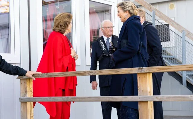 Queen Maxima wore an emilia metallic tweed jumpsuit by Costarellos. Queen Silvia wore red blazer and pant suit