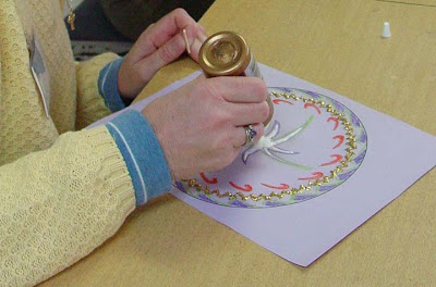 A participant works on a mandala art project