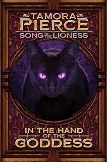 A black cat with purple eyes stares ahead.