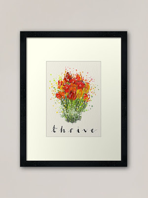 Photo shows a Thrive framed print on a wall.