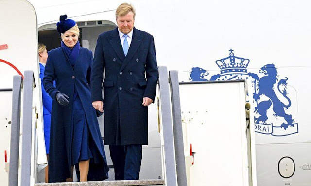 Queen Maxima's outfit, navy coat and dress, is from the fashion house Natan. Philip Treacy. President Zuzana Caputova