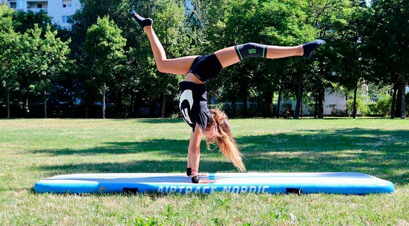 A girl practising on an airtrack