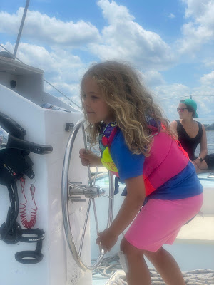 Child at the helm on Nauti-cat cruise