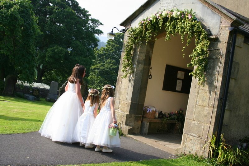 Beautiful little flower girls with floral halos and a lovely Hops door arch