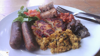 Brunch vegan sausages, tofu scramble, beans, potato cake, mushrooms, salad and toast (homemade bread)