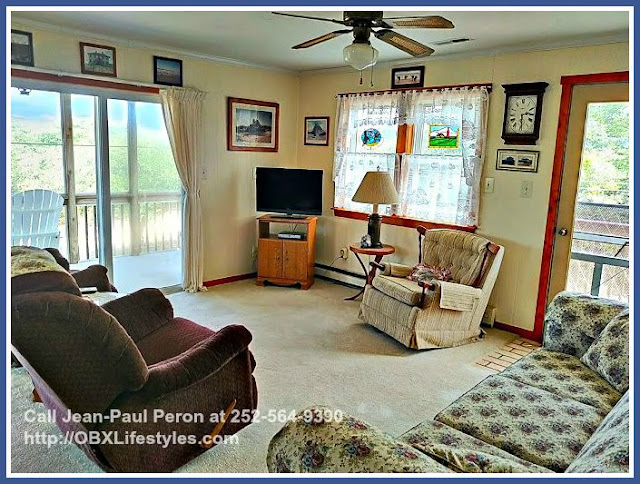 The living room of this 2 bedroom Outer Banks NC home for sale allows plenty of natural light to stream in. 