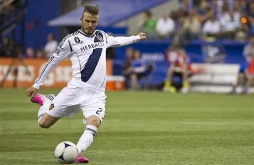 Los Angeles Galaxy player David Beckham scores from a free-kick against Montreal Impact