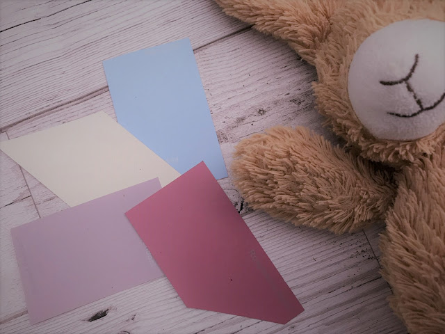 Colour charts laid out next to a cuddly bunny