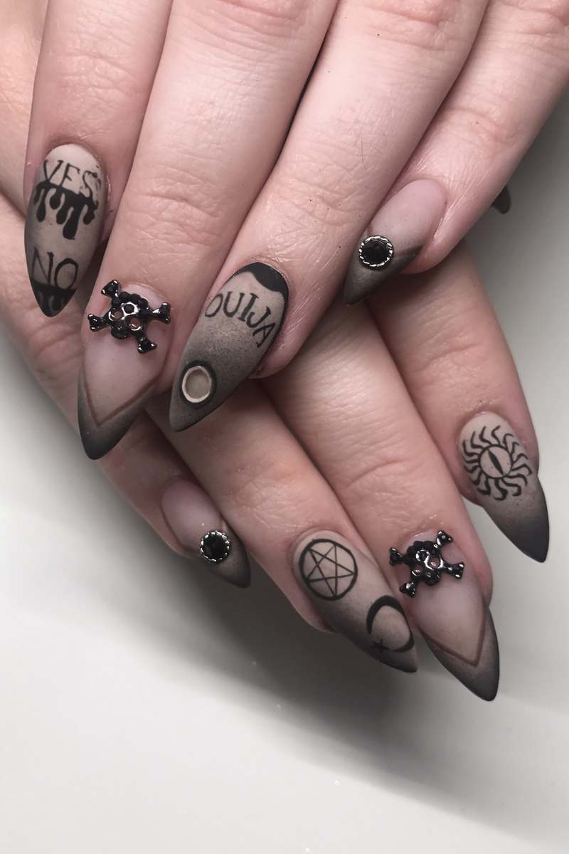 close-up of a female hand with wiccan Halloween nail look
