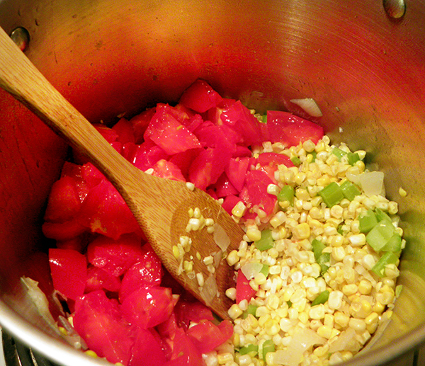 Corn and Tomatoes added to onion, garlic, and celery