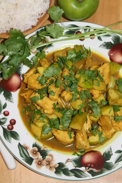 Finished plate of Chicken and Apple Indian Curry with a bowl of rice.