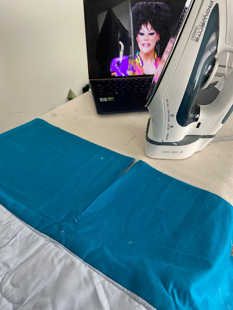 a bright blue section of the petticoat spread over an ironing board