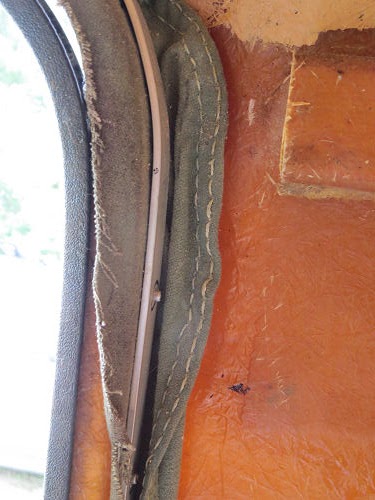 remains of a canvas and net screen door in a trailer