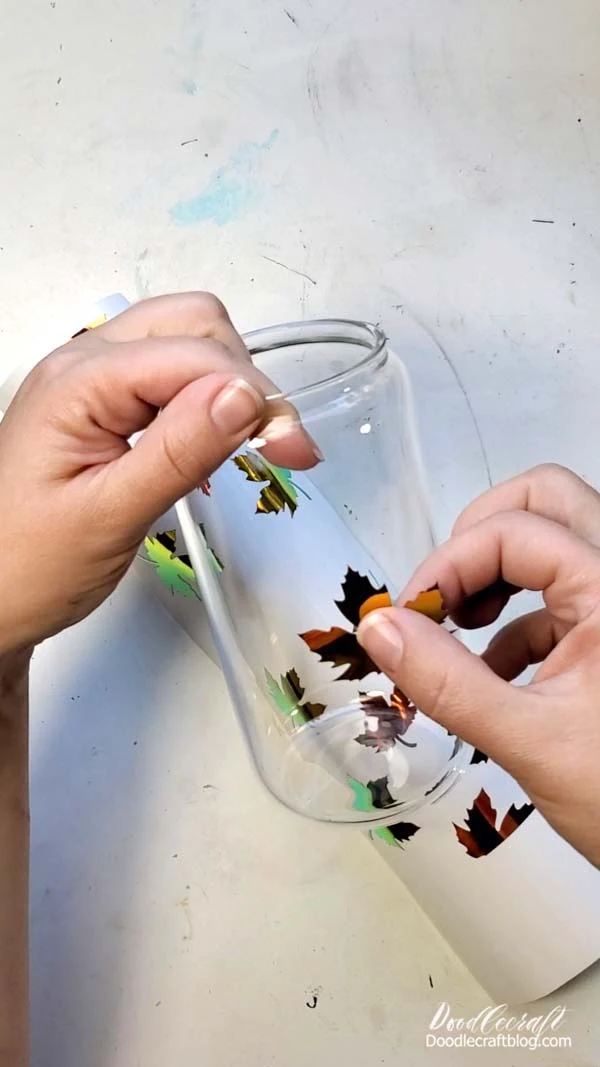 Holographic Vinyl Autumn Leaf Glass Can with HTVRONT Step 2: Weed Excess Vinyl Now remove the extra vinyl from the cut out maple leaves or other fun design. This leaves behind a bunch of cut out leaf stickers from the permanent vinyl.
