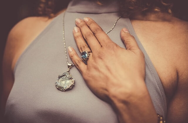 woman wearing bold necklace and ring