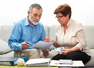 senior couple checking life insurance contract form