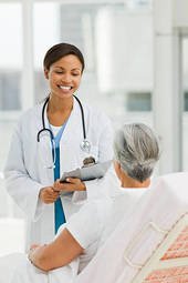 smiling-female-doctor-talking-with-senior-patient
