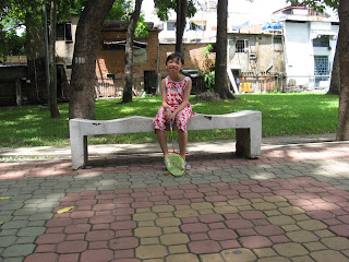 a little girl on a stone bench