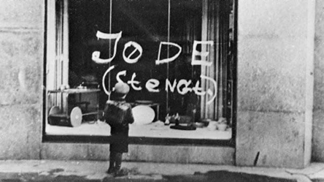 Anti-semitic graffiti on a shop window in Oslo, 1941. A small boy reads the message "Jew (closed)". (Photo by Keystone/Hulton Archive/Getty Images)