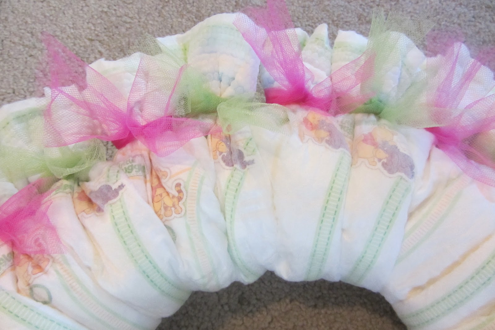 Tie tulle onto each diaper to hide rubber bands .