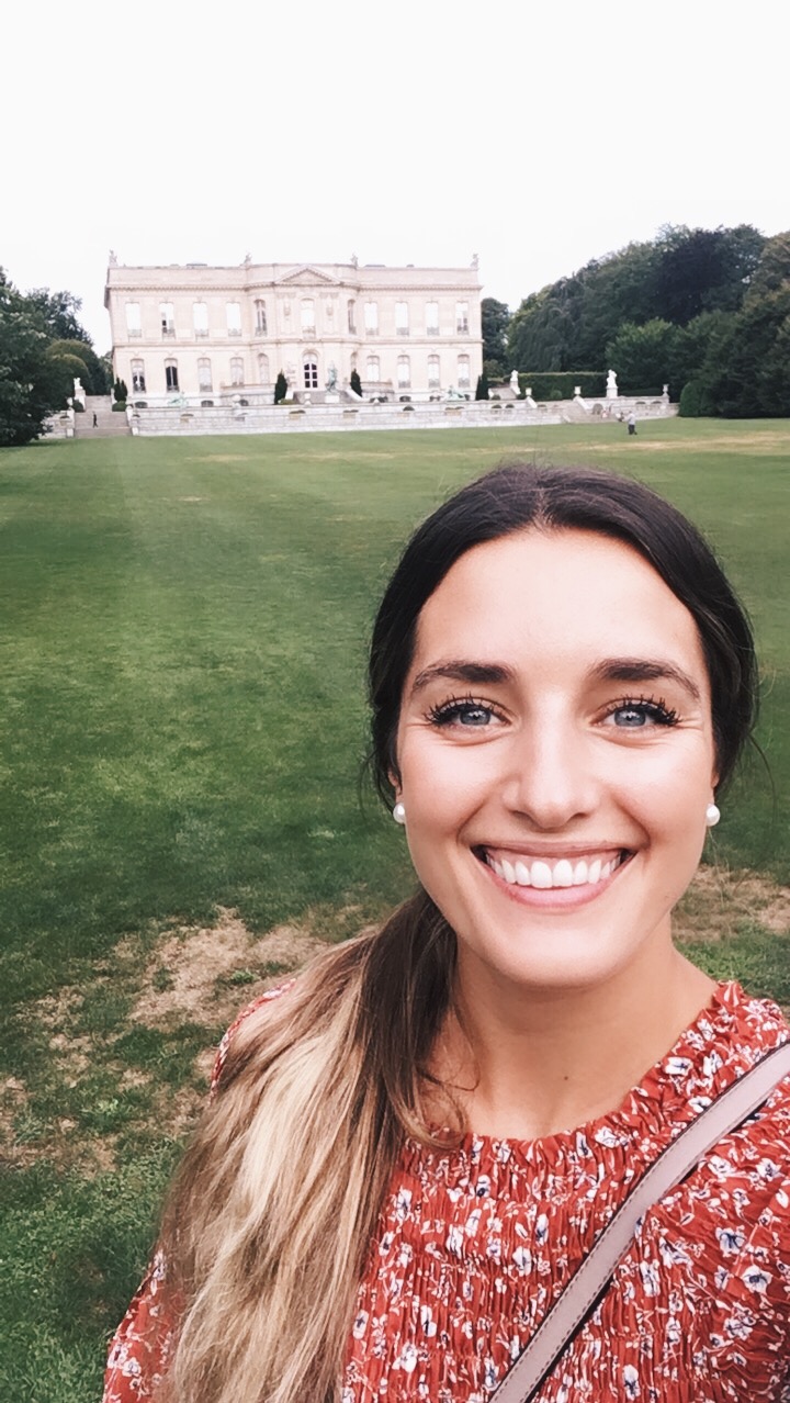 Girl smiling in front of Newport mansion