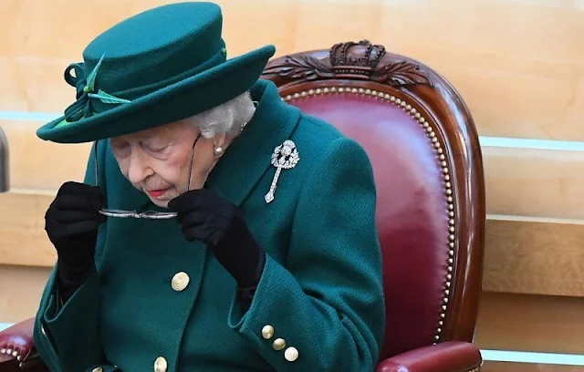 The Queen selected Queen Mary's Diamond Thistle Brooch for her lapel. Prince of Wales and Duchess of Cornwall