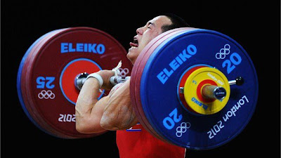 Om Yun Chol of DPR Korea breaks the Olympic record in the men's 56kg clean and jerk Weightlifting