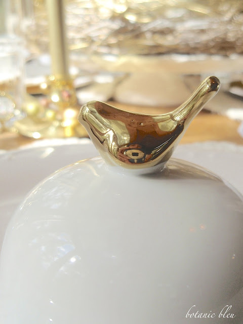 Thanksgiving gold and white table setting with gold bird topped white cloche