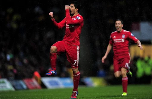 Liverpool striker Luis Suárez celebrates after scoring from 45-yard out against Norwich