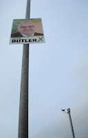 Searching for Paul Butler - Sinn Fein poster on a lamppost with a traffic camera in the background