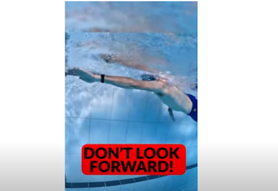 Picture of a swimmer doing freestyle swimming and looking forward as he swims. Look down when you are doing freestyle