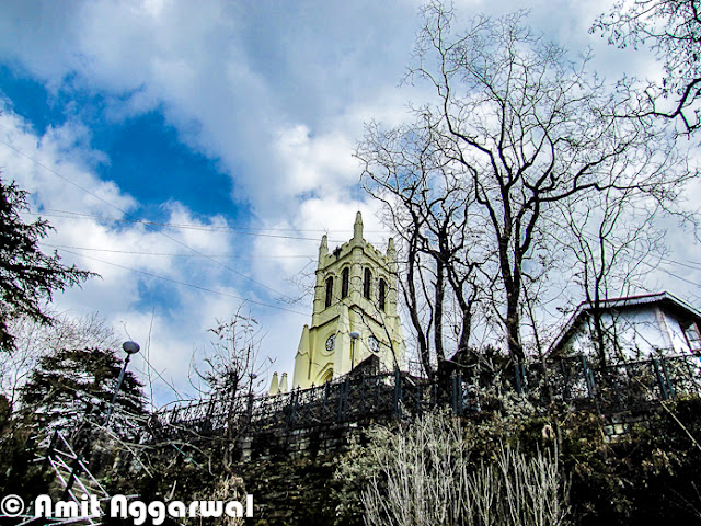 After some wonderful Photo Journeys from Shimla (IIAS, Jakhu & Sankat Mochan), here is another one by Amit Aggarwal. This Photo Journey shares more about Shimla Town and it's beauty.First photograph of this Photo Journy shows a very old Clock on Mall Road. This is places at BSNL office building, which is just in the beginning of Mall Road when we come from Himachal Pradesh University at Summer Hill.Here is a colorful building on other end of Mall Road of Shimla. Although Hotel hoardings are on left side of the building, but it's office of various High Court Advocates.Here is a main Gate of High Court Shimla. High Court Shimla is near to Mall Road and parking area is just next to mall road only.Most of the buildings around Shimla are quite interesting with slanting roofs, which are important in regions which get heavy snowfall and rains.Shimla is extremely dense and day by day it's spreading like other big cities of India. During a short visit to Shimla, every tourist like this city - It's beauty, freshness and weather. But Shimla has nt enough resources for people living there. Water is one of the biggest problem during summers. This sounds weird that hill station faces water-problem in summers, but that's true. Shimla has not big river nearby and the way population is increasing, it's always difficult to meet the requirement even when every year lot of efforts go into bringing water to the town from surrounding riversSince town was not planned to handle this much population, not we can easily see severe traffic jams around roads in Capital City of Himachal. Parking is one of the biggest problem as majority of families have four wheelers now and hardly any space to park. Tourism department has tried to solve parking problem for tourists who visit the town in their own carsColorfulness of houses in Shimla is very attractive and different from other cities. Being a hilly station, it has a big opportunity to do show-off because more number of houses can be seen at one point of time, which is not that possible in plains Here is a photograph of starting of shopping area on Mall Road, which is quite near to office of District Commissioner and Kalibari Temple. The building on left  is BSNL head office of Himachal Pradesh and on right are various showrooms having brands like Reebok, Adidas. There is a shop called 'City Point' near the beginning which is very famous for pastries..Mall road is most popular place in Shimla for Shopping. Apart from popular brands, there are some interesting shops to get woolens, stuff for kids and girls etc.Many offices of Shimla are around Mall Road and others are towards Chhota Shimla and New Shimla region. Here is a photograph showing SP office of Shimla. Most of the office buildings are old and built in British styleShimla Townhall, which is quite popular among Bollywood folks. Most of the bollywood folks who come to Shimla for shooting, choose this building of one or more shots. Movies like Kareeb are almost completely show around this place. This is center of Mall Road and most crowded place around Ridge ground of Shimla A view of beautiful Church on Ridge, Shimla. This photograph is clicked from Mall Road which is just below this Church.A view of World's highest Hanuman Statue at such a high altitude. This photograph is shot from Mall Road and this statue  is higher that these high deodar trees. It's 108 feet high ! To know more about Jakhu Temple and this Hanuman Statue, please check out - http://phototravelings.blogspot.com/2012/04/jakhu-temple-with-worlds-highest.htmlHere is a photograph of Indira Gandhi State Sport Complex which is located in the middle of Mall Road, which is just in front of HPTDC Lift. Indira Gandhi Sports Complex in Shimla is a very famous complex not only in Himachal Pradesh but also in India. It provides all required facilities for organizing events of sports as well as trade. This complex has been organizing so many events for a longer period of time. The venue is liked by sports and other event organizers as they get enjoyments together, one they do their professional work and two they get a chance to see the natural sight of Shimla. IGSS complex provides a very big space which can be utilized as per the requirement of an indoor as well as outdoor event. The complex provides good facility to sit and to enjoy for the people who get there to entertain them.