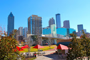 The mirrored glass building in the foreground (near red umbrellas) is The .