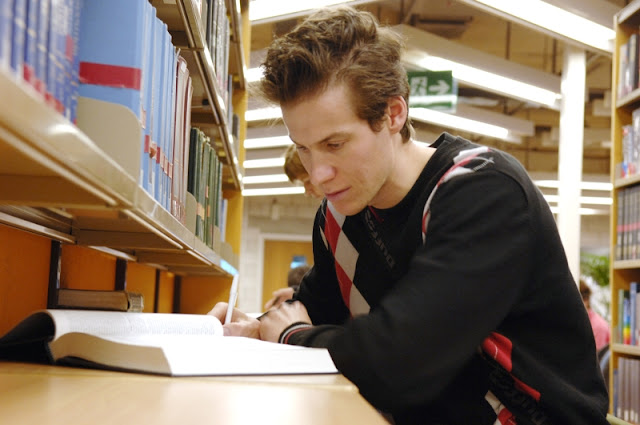 Guy studying in library