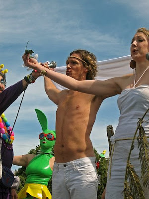 drag queen arm partially blocks view of a hunky jesus