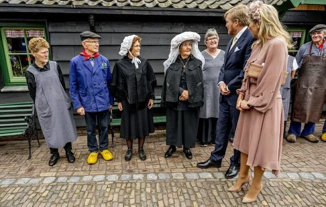 Queen Maxima wore a ruffled light pink silk dress by Natan. Berry Rutjes flower headband. Brown suede flat shoes