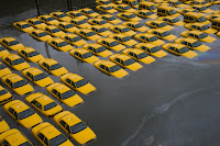 In this Oct. 30, 2012 file photo, a parking lot full of yellow cabs in Hoboken, N.J. is flooded as a result of Superstorm Sandy. (Credit: AP Photo/Charles Sykes) Click to Enlarge.