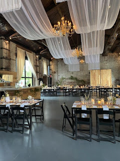 White sheer drapes suspended over the main room at The Green Building