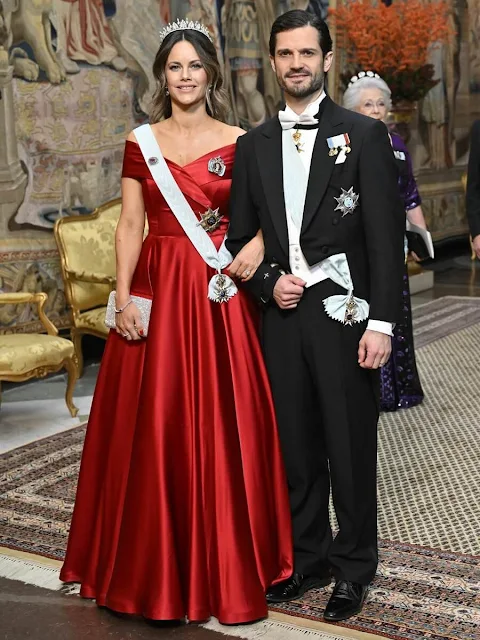 Crown Princess Victoria is wearing Camilla Thulin floral skirt and Connaught tiara. Princess Sofia is wearing Ida Lanto red gown